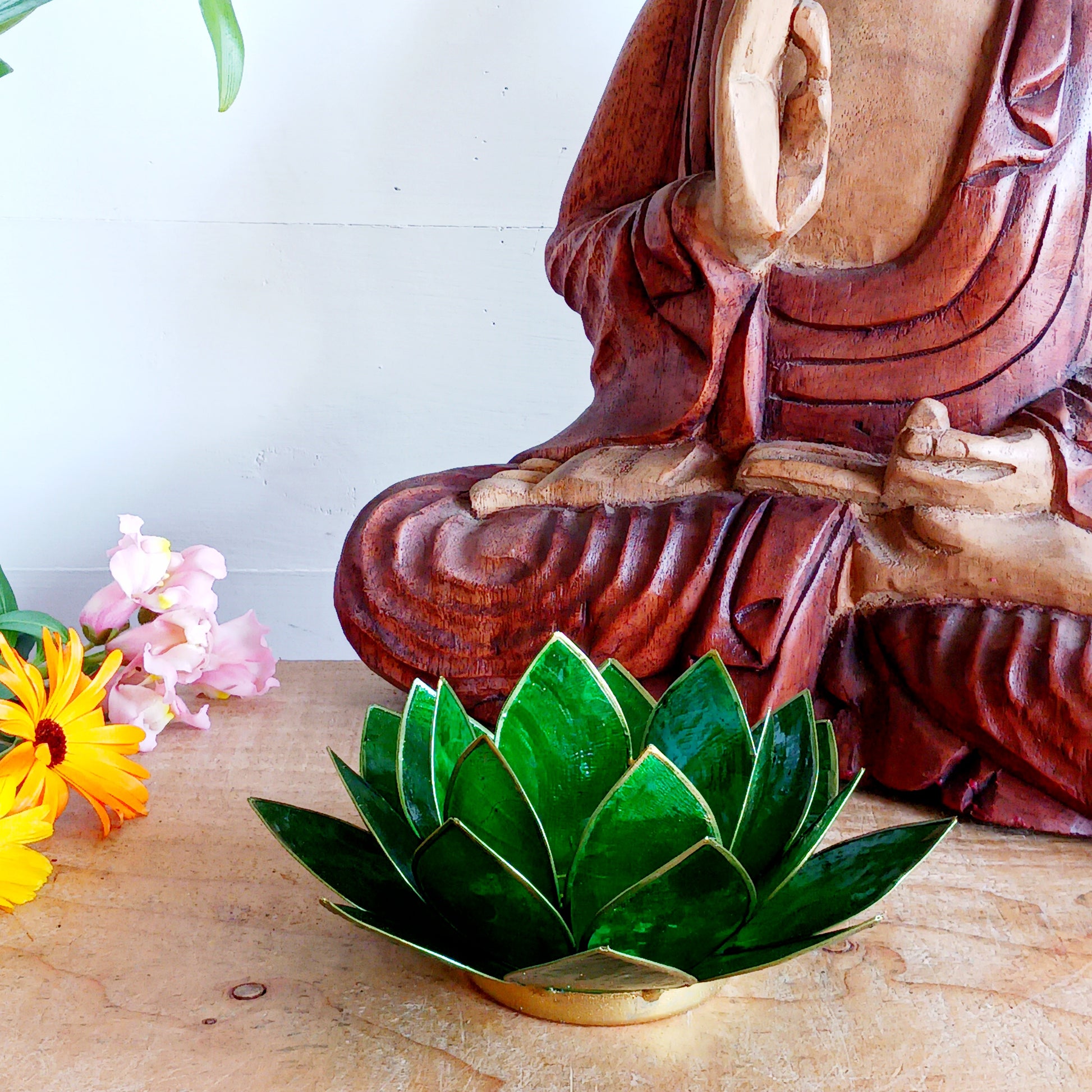 Illuminate your space with the peaceful elegance of our Capiz Shell Lotus Flower Candle Holder. Symbolizing enlightenment and serenity, this stunning handcrafted piece features delicate green petals edged in gold, forming the iconic lotus shape.