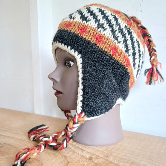 Stay cozy and stylish with our handmade chunky wool earflap hats, crafted in Nepal by skilled women artisans in Kathmandu. Each hat is 100% pure wool and features a soft polar fleece lining for extra warmth and comfort. Perfect for cold winter days, outdoor adventures, or adding a touch of handmade charm to your look.