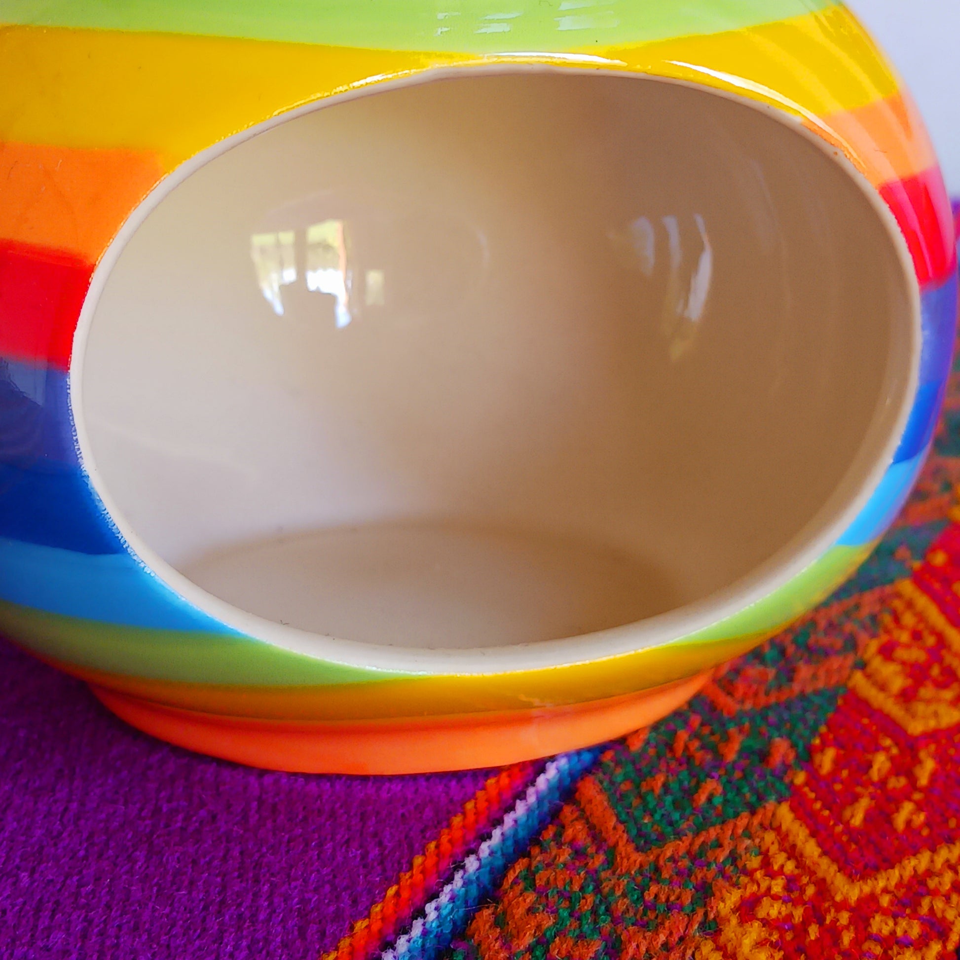 Wonderfully cheerful rainbow stripe ceramic oil burner. The vibrant stripes are hand painted giving each piece individual character.