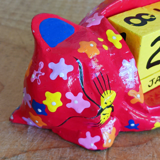Bring a touch of charm and colour to your workspace with this fun, hand-painted wooden cat calendar. Featuring a peaceful sleeping cat design, this eco-friendly calendar is both practical and decorative. Simply rotate the wooden blocks each day to keep track of the date—no paper waste, no replacements needed. A reusable, year-round desk accessory that makes a thoughtful, sustainable gift for cat lovers, students, and anyone who appreciates unique, handmade treasures.