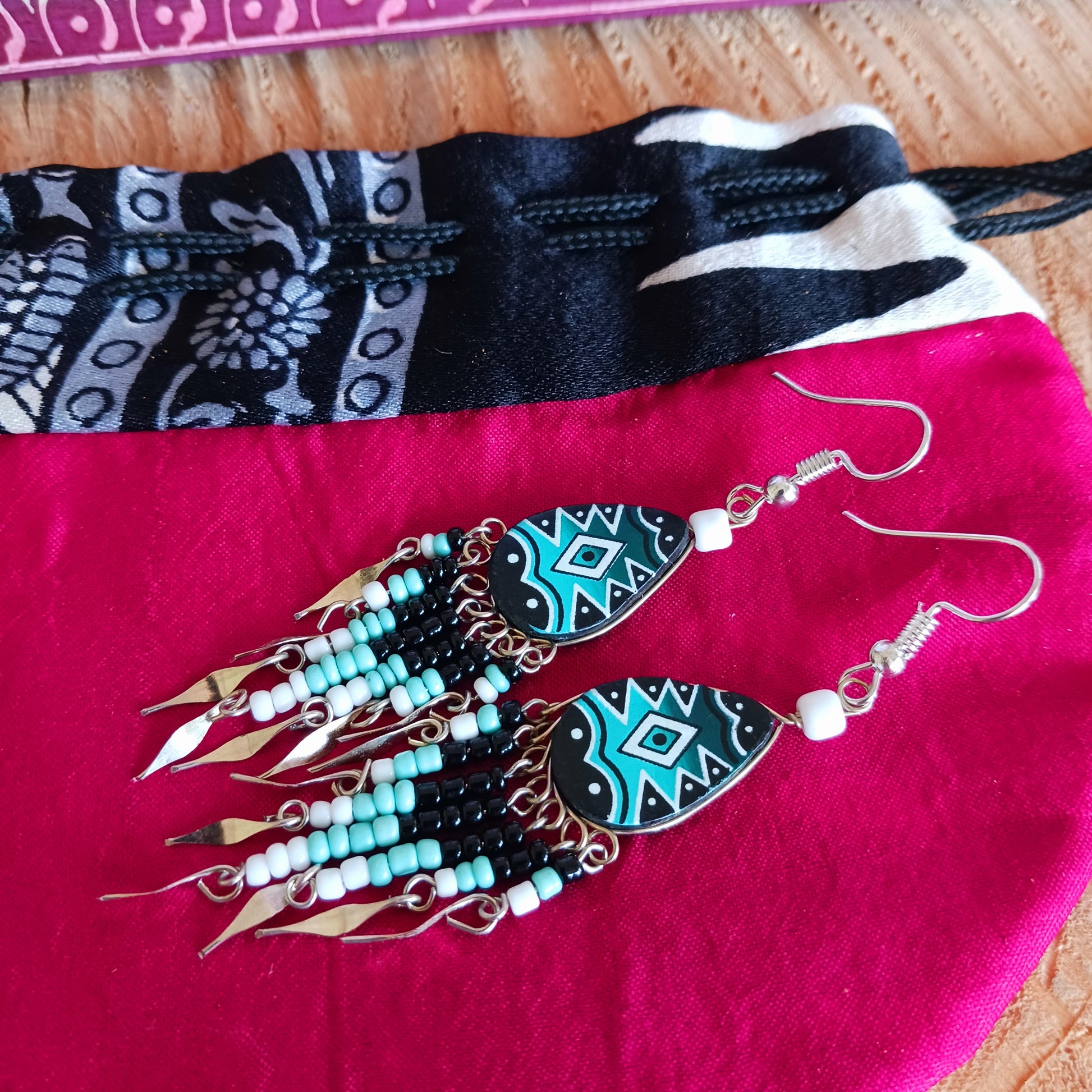 These beautiful and eye-catching earrings are handmade in Peru and feature traditional Incan patterns on the front, the back is coloured black. 
