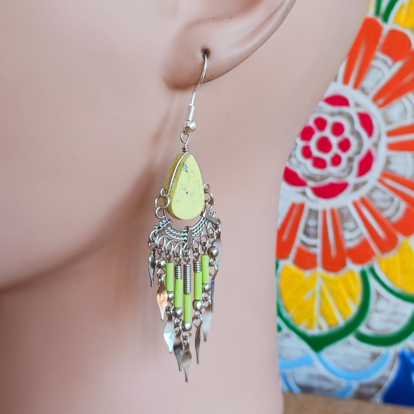 Add a touch of bohemian beauty to your look with these handmade Peruvian yellow stone and beaded earrings. Featuring a pale yellow stone paired with matching beads and finished with silver-plated hooks, each pair is carefully crafted in small workshops in Peru.
