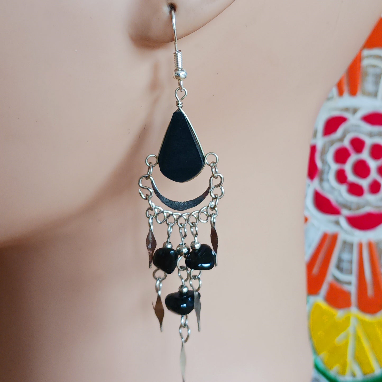 Add a touch of bohemian beauty to your look with these handmade Peruvian stone earrings. Featuring black stones and finished with silver-plated hooks, each pair is carefully crafted in small workshops in Peru.