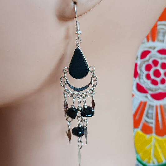 Add a touch of bohemian beauty to your look with these handmade Peruvian stone earrings. Featuring black stones and finished with silver-plated hooks, each pair is carefully crafted in small workshops in Peru.