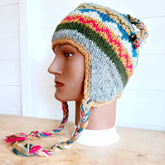 Stay cozy and stylish with our handmade chunky wool earflap hats, crafted in Nepal by skilled women artisans in Kathmandu. Each hat is 100% pure wool and features a soft polar fleece lining for extra warmth and comfort. Perfect for cold winter days, outdoor adventures, or adding a touch of handmade charm to your look.