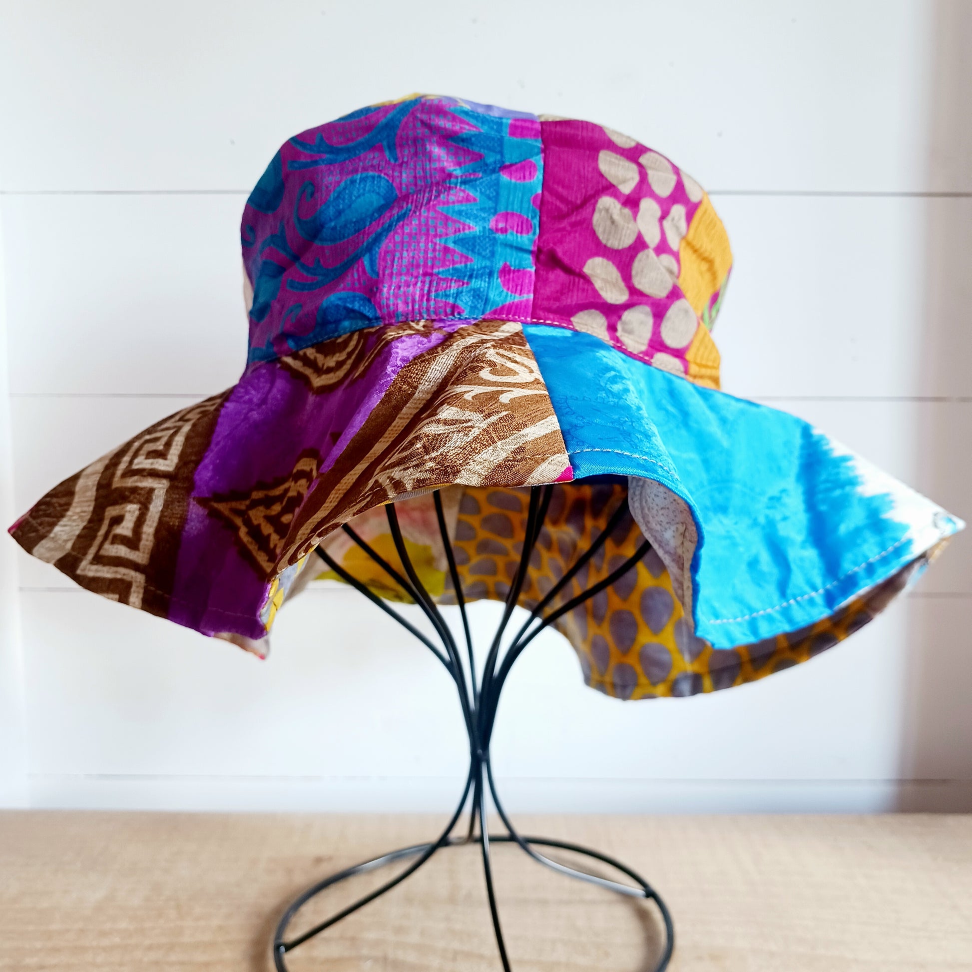 This colourful sunhat is made from patches of remnants from saris. Each hat is unique and features a wide brim to keep the sun from your face and keep you cool, lined with plain cotton to keep you even cooler. These hats are lightweight so easy to carry around in your bag. Ideal for travelling and festivals.