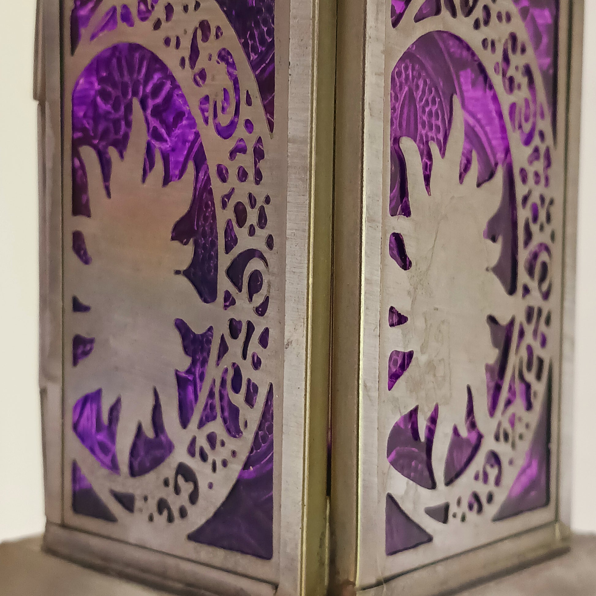 Bring warmth, colour and spiritual harmony to your home with this beautiful Moon & Stars Glass Lantern. Designed with vibrant coloured glass panels and a decorative metal cut-out canopy, this lantern creates a calming glow that enhances meditation spaces, yoga rooms and home décor.