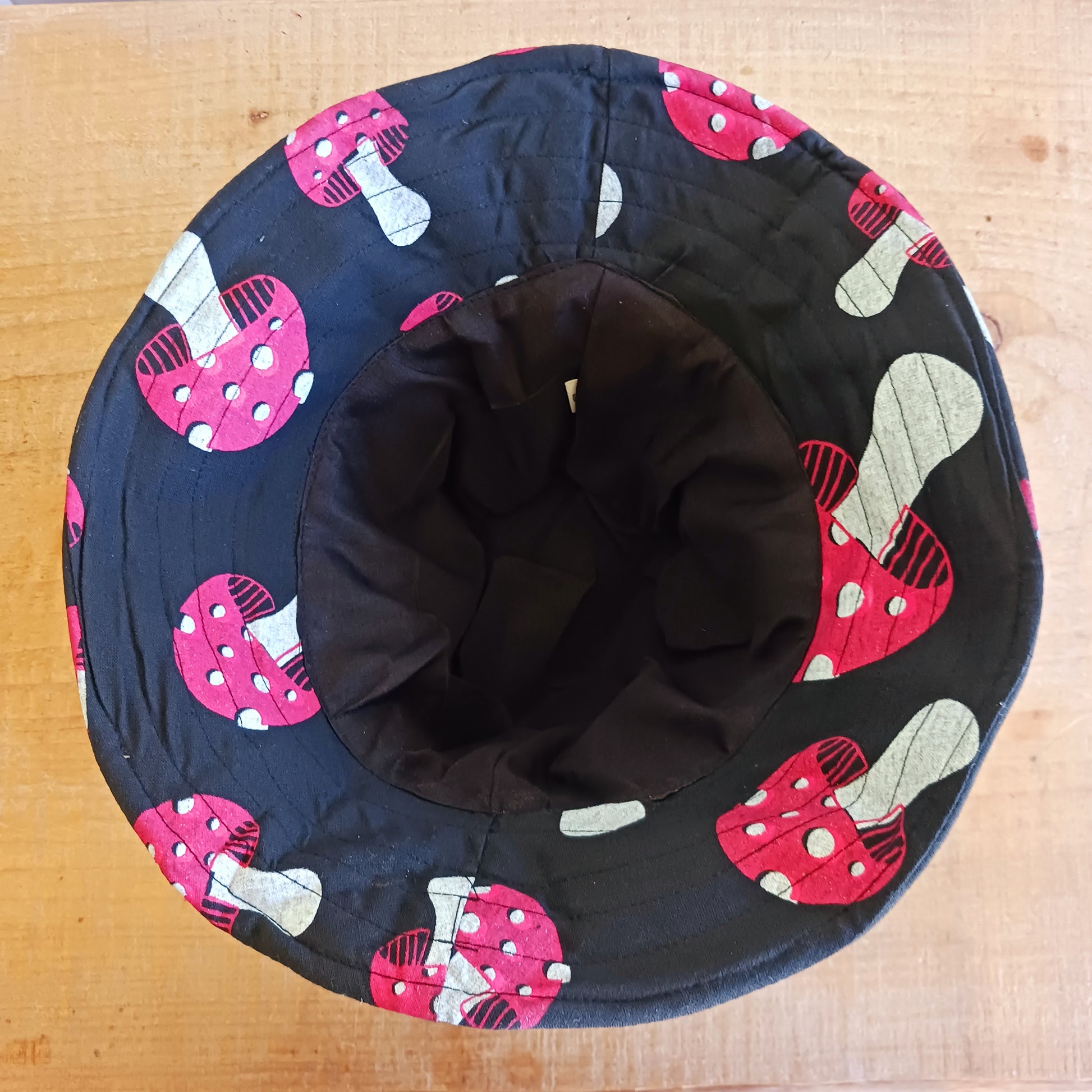 Stand out from the crowd with this lightweight Festival Mushroom Print Bucket Hat. Designed for festival season, holidays, beach days, and everyday summer wear, this stylish bucket hat features a bold all-over mushroom print that adds a fun, eye-catching touch to any outfit.