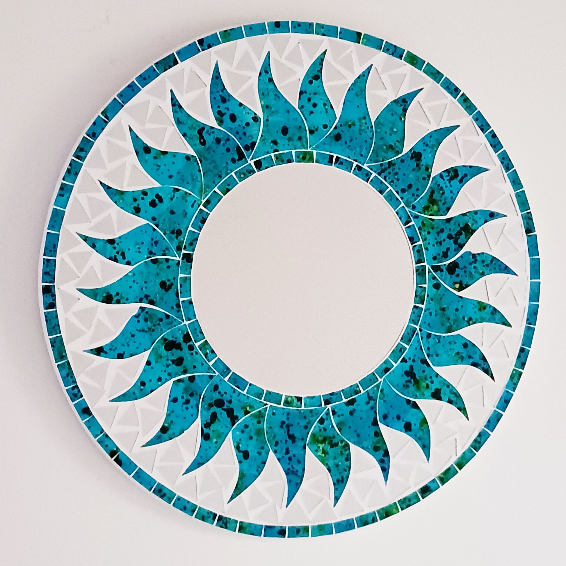 Add warmth, energy, and artistic charm to your home with this beautiful Vibrant Turquoise Mosaic Sun Mirror. Designed with dazzling turquoise mosaic tiles arranged in a radiant sunburst pattern, this captivating wall accent instantly brightens any room. 