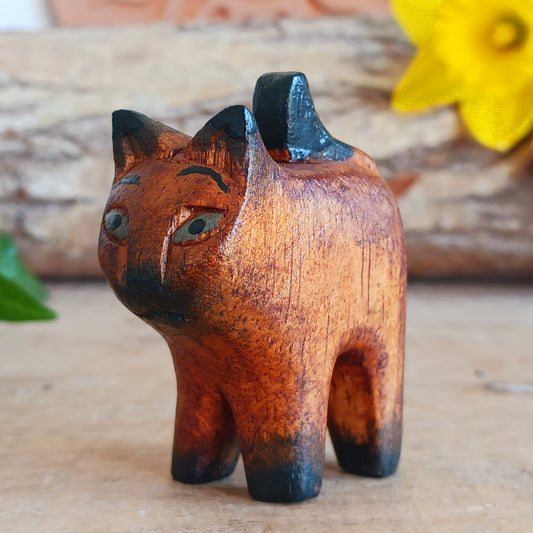 Bring warmth and charm to your home with this hand carved rustic mini cat, a delightful wooden figurine full of personality. Carefully crafted from Jempinis wood, each tiny cat is individually carved by skilled artisans in Indonesia and finished with subtle painted details that give every piece its own unique character.