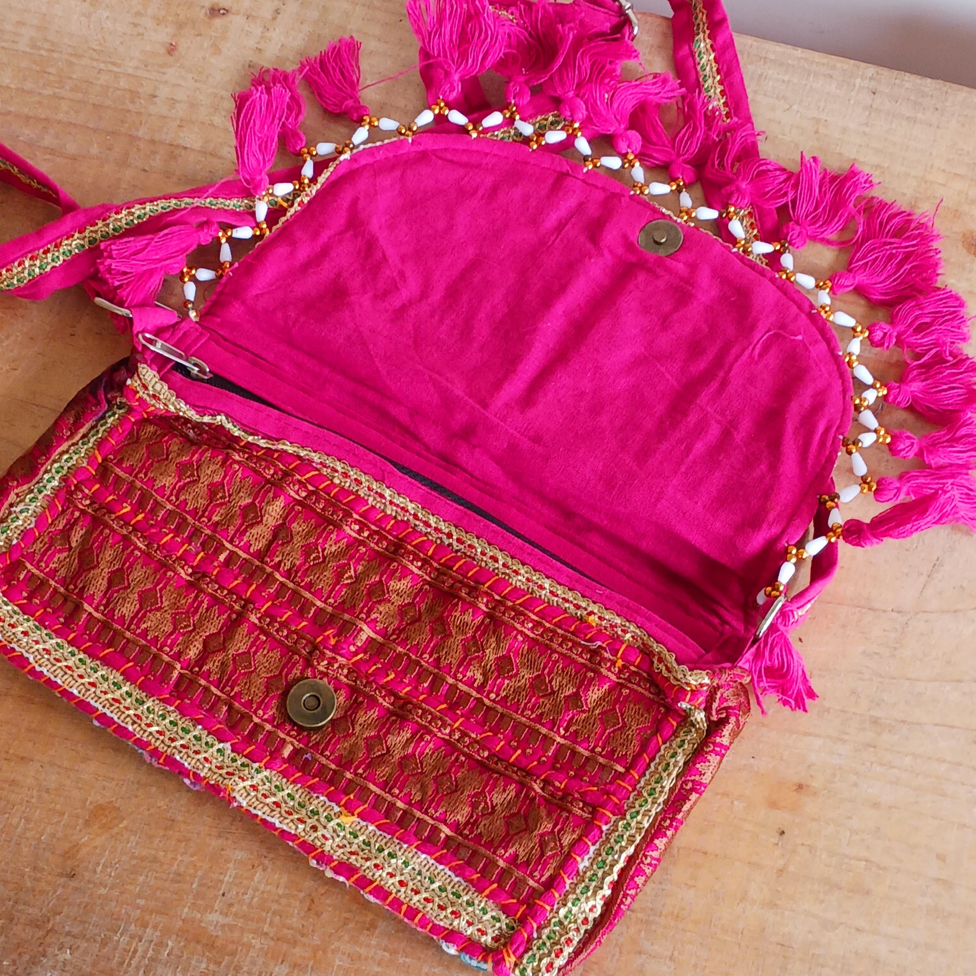 Add a vibrant touch to your everyday style with this beautifully handmade Indian embroidered handbag, crafted from upcycled materials for a truly sustainable fashion statement.