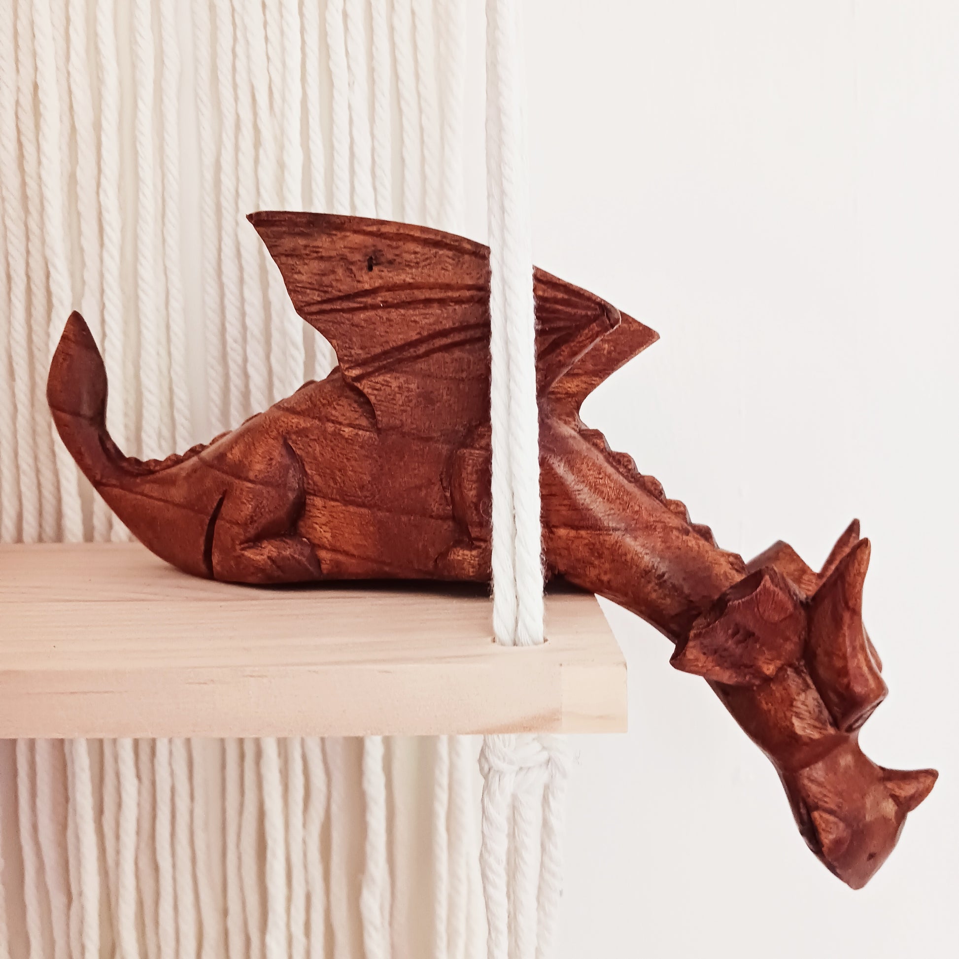Bring personality and charm into your home with this beautiful hand-carved Shelf Dragon. Expertly crafted with intricate details, this whimsical dragon is designed to perch perfectly on any shelf, mantle, or display space. Its expressive features, artisan carving, and warm natural wood finish make it a captivating accent piece for fantasy lovers, collectors, and anyone who appreciates unique décor.