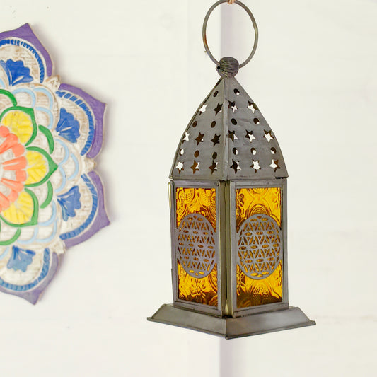 Bring warmth, colour and spiritual harmony to your home with this beautiful Tree of Life Glass Lantern. Designed with vibrant coloured glass panels and a decorative metal cut-out canopy, this lantern creates a calming glow that enhances meditation spaces, yoga rooms and home décor.