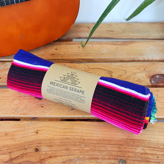 Bring bold colour and cultural charm into your space with our Mexican Serape Vibrant Indigo Blanket. Inspired by traditional Mexican festival textiles, this eye-catching throw features striking pink tones and classic serape stripes that instantly brighten any room.