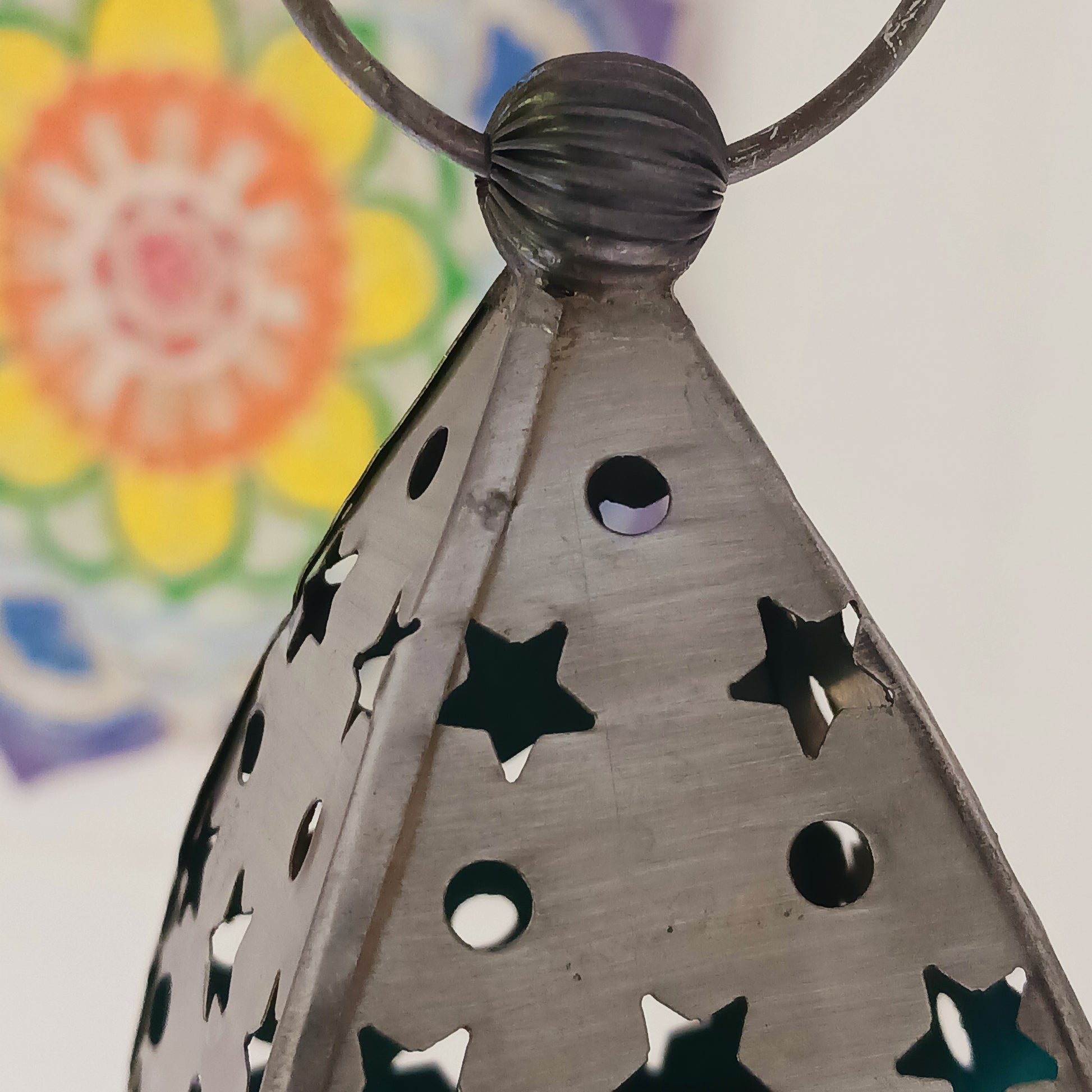 Bring warmth, colour and spiritual harmony to your home with this beautiful Om Symbol Glass Lantern. Designed with vibrant coloured glass panels and a decorative metal cut-out canopy, this lantern creates a calming glow that enhances meditation spaces, yoga rooms and home décor.