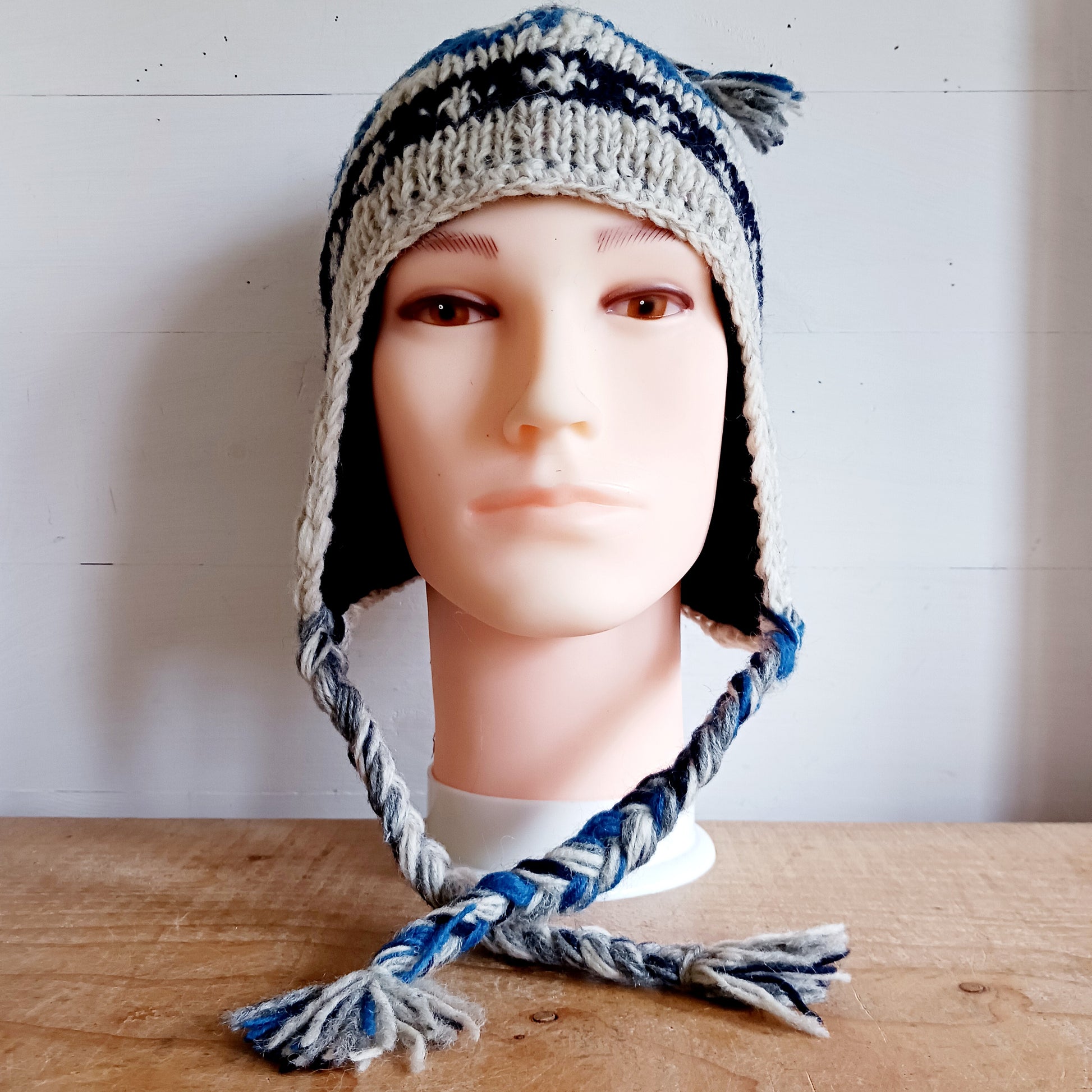 Stay cozy and stylish with our handmade chunky wool earflap hats, crafted in Nepal by skilled women artisans in Kathmandu. Each hat is 100% pure wool and features a soft polar fleece lining for extra warmth and comfort. Perfect for cold winter days, outdoor adventures, or adding a touch of handmade charm to your look.