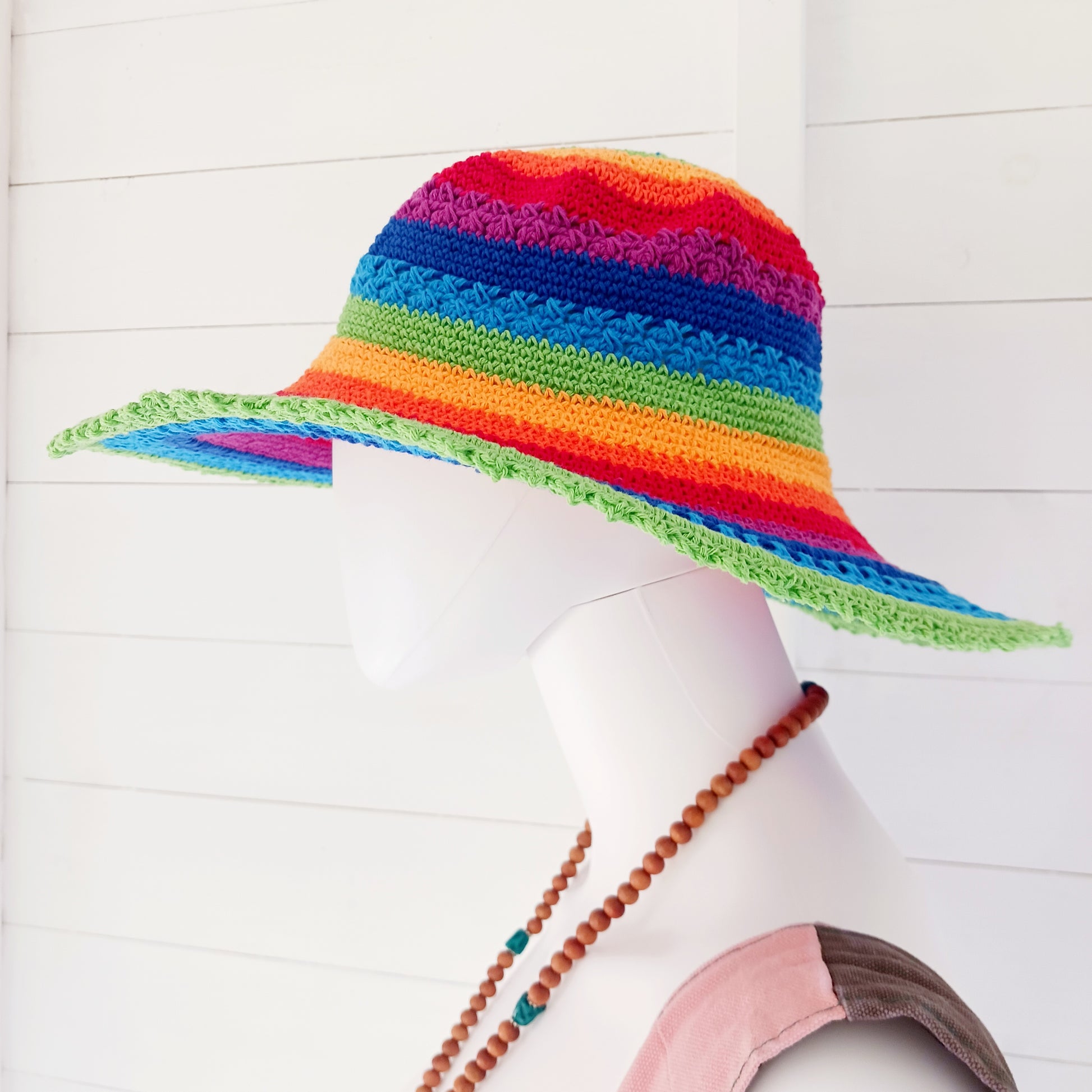 This lovely crochet cotton summer sun hat is perfect for summertime with it's vibrant rainbow colours. Each hat has a malleable wire woven into the rim to help keep the shape. Ideal for holidays and festivals.