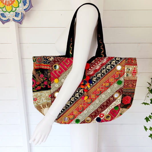 This beautiful large Indian bag comes with a wide shoulder strap and plenty of space inside for your personal items. In a patchwork style design, this bag is intricately embroidered with a traditional bohemian pattern. The bag is fully lined throughout.