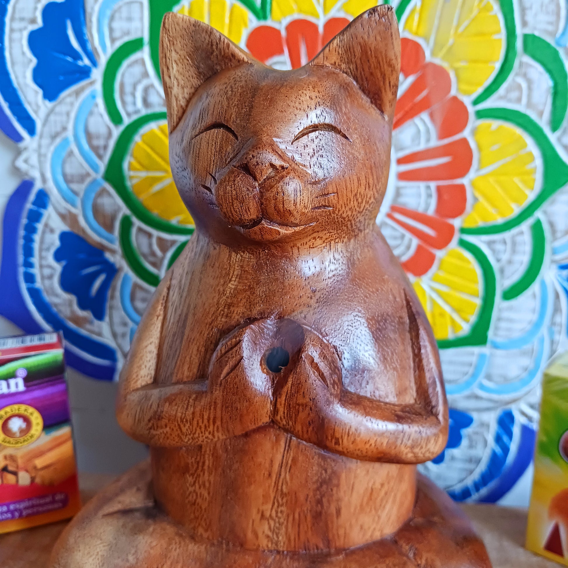Bring a sense of peace, playfulness, and artistry into your space with this Hand-Carved Wooden Yoga Cat Incense Burner. Each piece is lovingly crafted by skilled Indonesian artisans from sustainably sourced Suar wood, showcasing the perfect blend of mindfulness and feline charm.