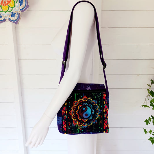 This lovely Yin Yang shoulder bag is both practical and unusual. There are three zipped compartments ensuring you keep your valuables safe. The Yin Yang design on the front is set in a colourful mandala on the flap, and this is secured with a velcro strips. The staps are adjustable to suit your style.