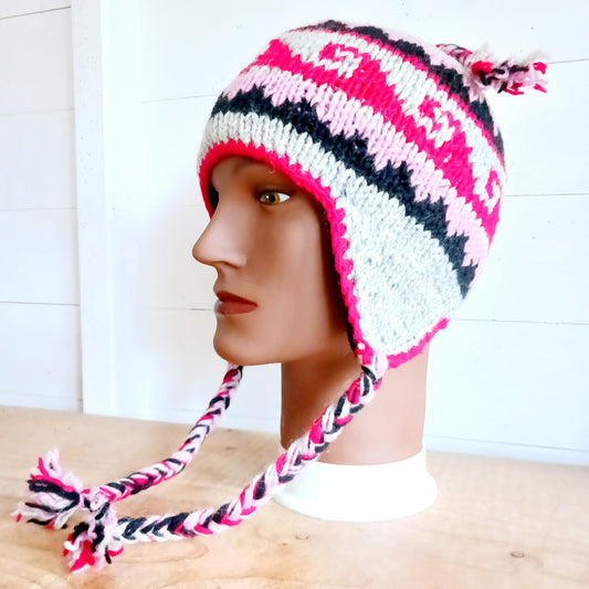 Stay cozy and stylish with our handmade chunky wool earflap hats, crafted in Nepal by skilled women artisans in Kathmandu. Each hat is 100% pure wool and features a soft polar fleece lining for extra warmth and comfort. Perfect for cold winter days, outdoor adventures, or adding a touch of handmade charm to your look.