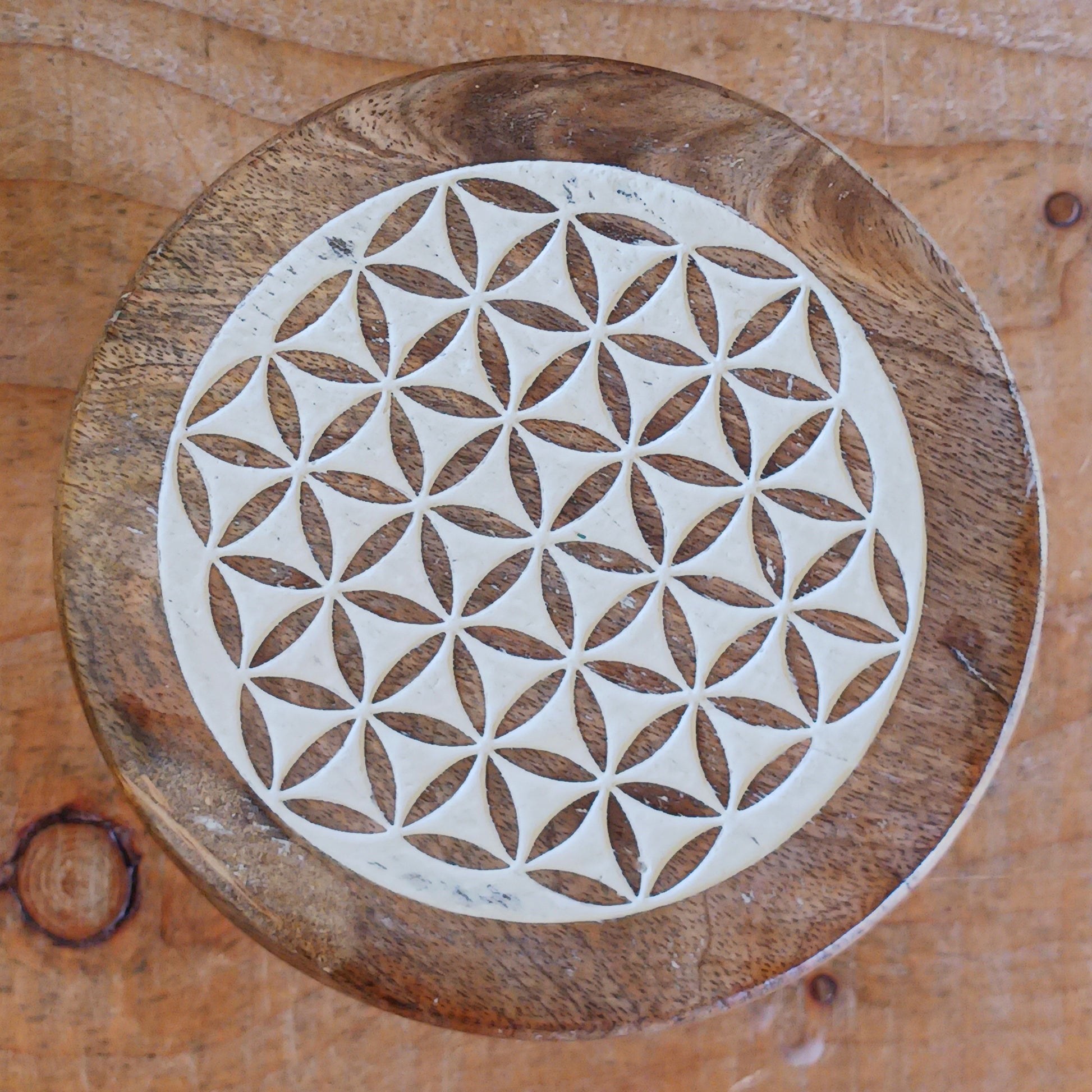 Bring the beauty of sacred geometry into your space with these compact Flower of Life tables. Handcrafted from solid mango wood, each table features a finely engraved Flower of Life symbol on top – an ancient pattern representing the interconnectedness of all life. 