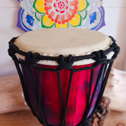 Awaken your rhythm with this handcrafted Rainbow Wooden Djembe from the heart of Indonesia. Standing 30cm tall with a 6–8" head, this compact drum carries the earth’s natural resonance and the spirit of Balinese ceremony. Wrapped in vibrant rainbow sarong fabric and finished with a protective varnish, it radiates healing colour and joyful energy.