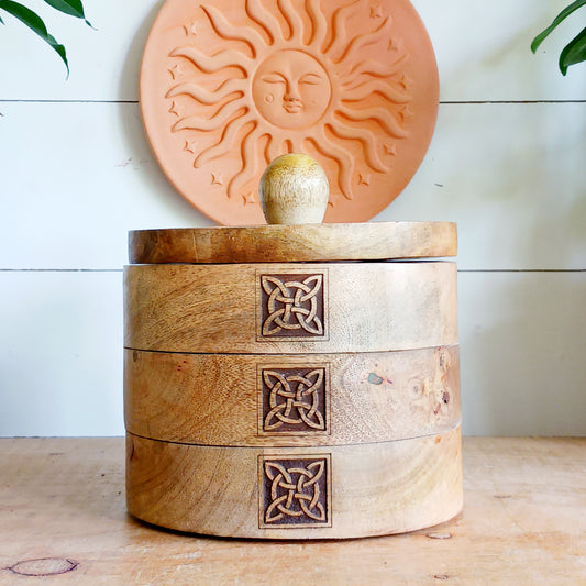 Bring timeless craftsmanship and functional beauty into your space with this Celtic Carved Revolving Storage Box, expertly hand-crafted from sustainable mango wood. Designed with both elegance and practicality in mind, this unique 3-tier swivel box opens smoothly from a central pivot, revealing three spacious compartments that fan out effortlessly.
