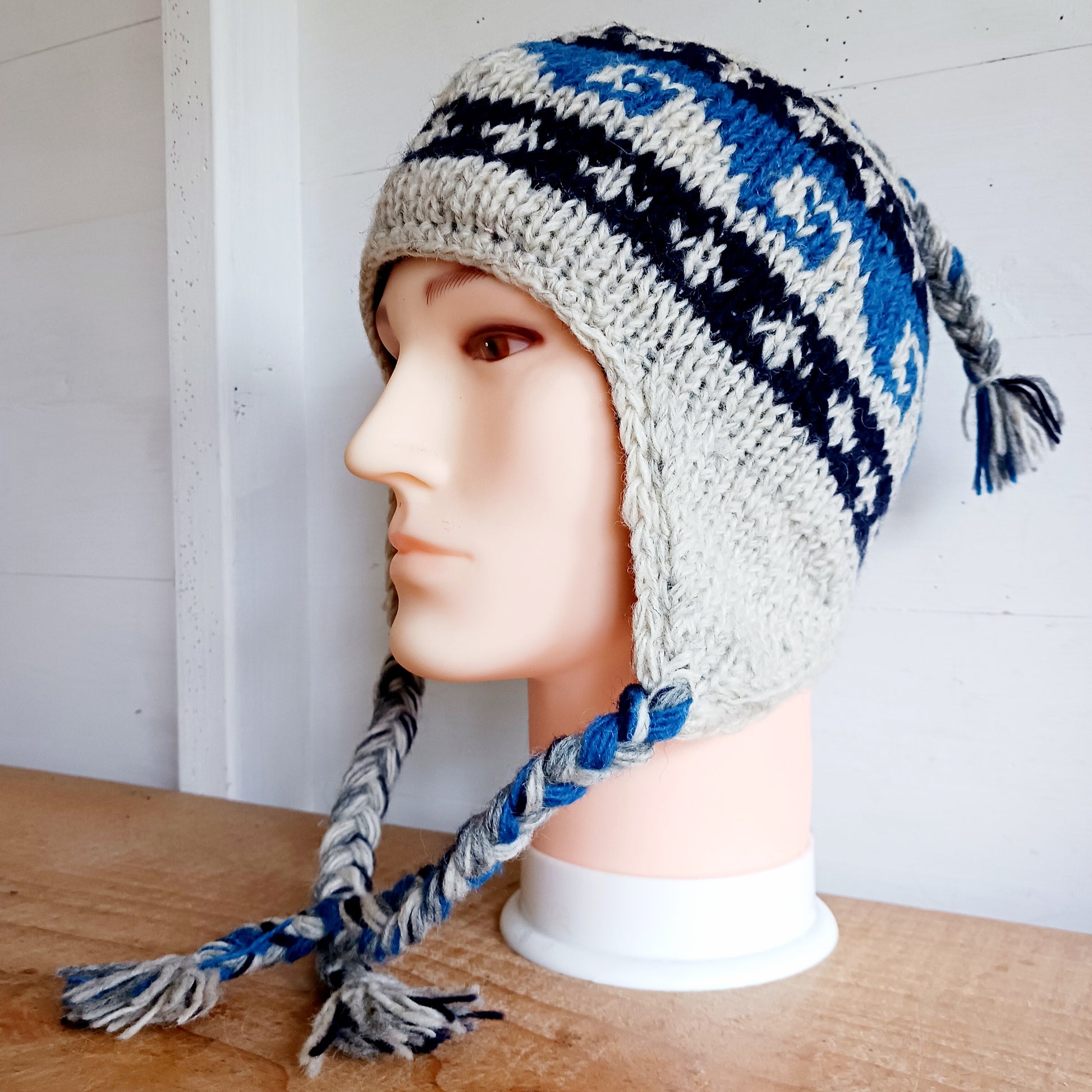 Stay cozy and stylish with our handmade chunky wool earflap hats, crafted in Nepal by skilled women artisans in Kathmandu. Each hat is 100% pure wool and features a soft polar fleece lining for extra warmth and comfort. Perfect for cold winter days, outdoor adventures, or adding a touch of handmade charm to your look.