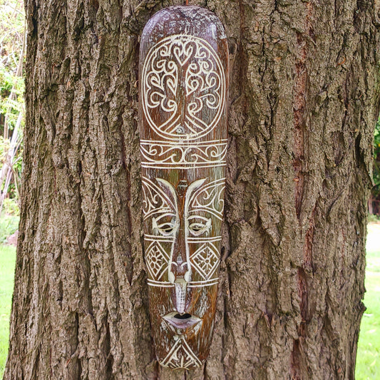 Bring the spirit of Celtic heritage into your home with this beautifully hand-carved Celtic wooden mask, featuring intricate knotwork and a Tree of Life pattern that symbolize eternity, unity, and tradition. Designed for lovers of cultural art and meaningful decor, this striking wall piece adds depth, character, and history to any space.