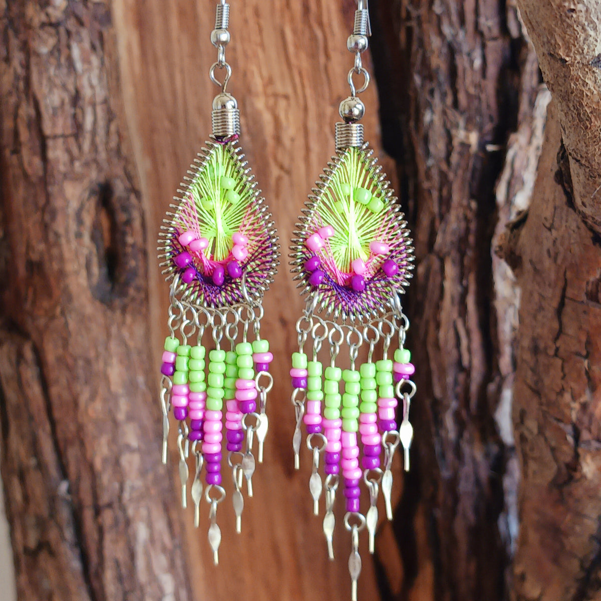 Add a splash of colour to your look with these beautiful handmade Peruvian woven teardrop earrings. Inspired by the vibrant colours and patterns of a peacock feather, each earring features intricate woven detailing complemented by coordinating beads and delicate silver-tone embellishments.