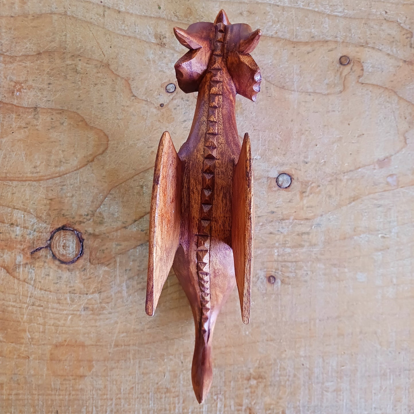 Bring personality and charm into your home with this beautiful hand-carved Shelf Dragon. Expertly crafted with intricate details, this whimsical dragon is designed to perch perfectly on any shelf, mantle, or display space. Its expressive features, artisan carving, and warm natural wood finish make it a captivating accent piece for fantasy lovers, collectors, and anyone who appreciates unique décor.