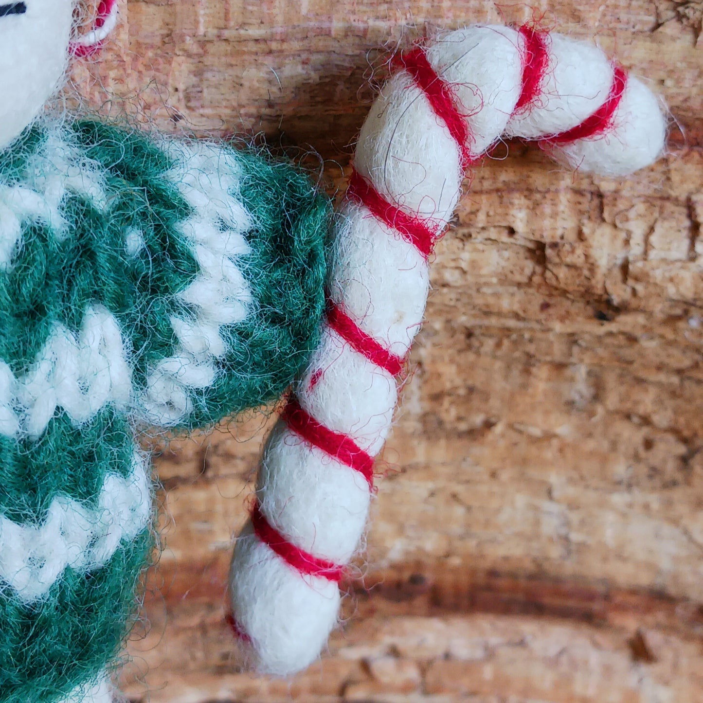 Meet our endearing little Christmas mice, dressed in vibrant elf knitwear, joyfully clutching a felt candy cane ready to spread festive cheer. Each ornament is lovingly handcrafted, capturing the magic and childlike wonder of the holiday season.