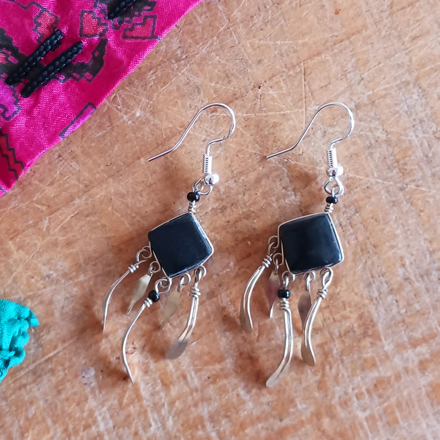 Add a touch of bohemian beauty to your look with these handmade Peruvian stone earrings. Featuring black stones and finished with silver-plated hooks, each pair is carefully crafted in small workshops in Peru.