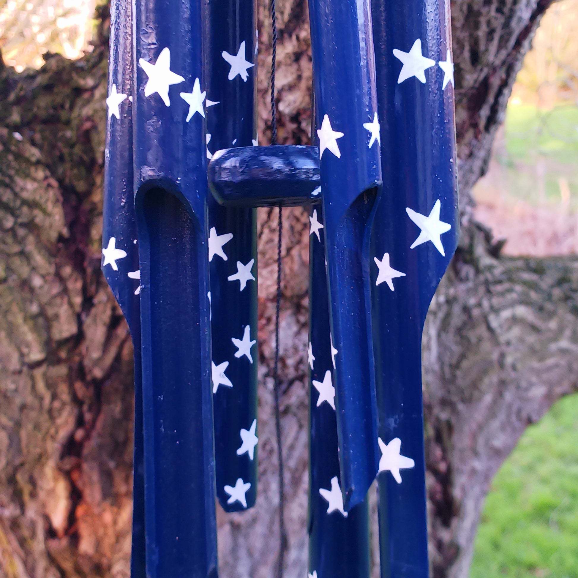 This great sounding bamboo windchime is perfect for hanging in a tree or from a wall in your garden, or even in your bedroom! This windchime has been hand painted in a calming night sky design - bringing calm to whichever place you hang it.