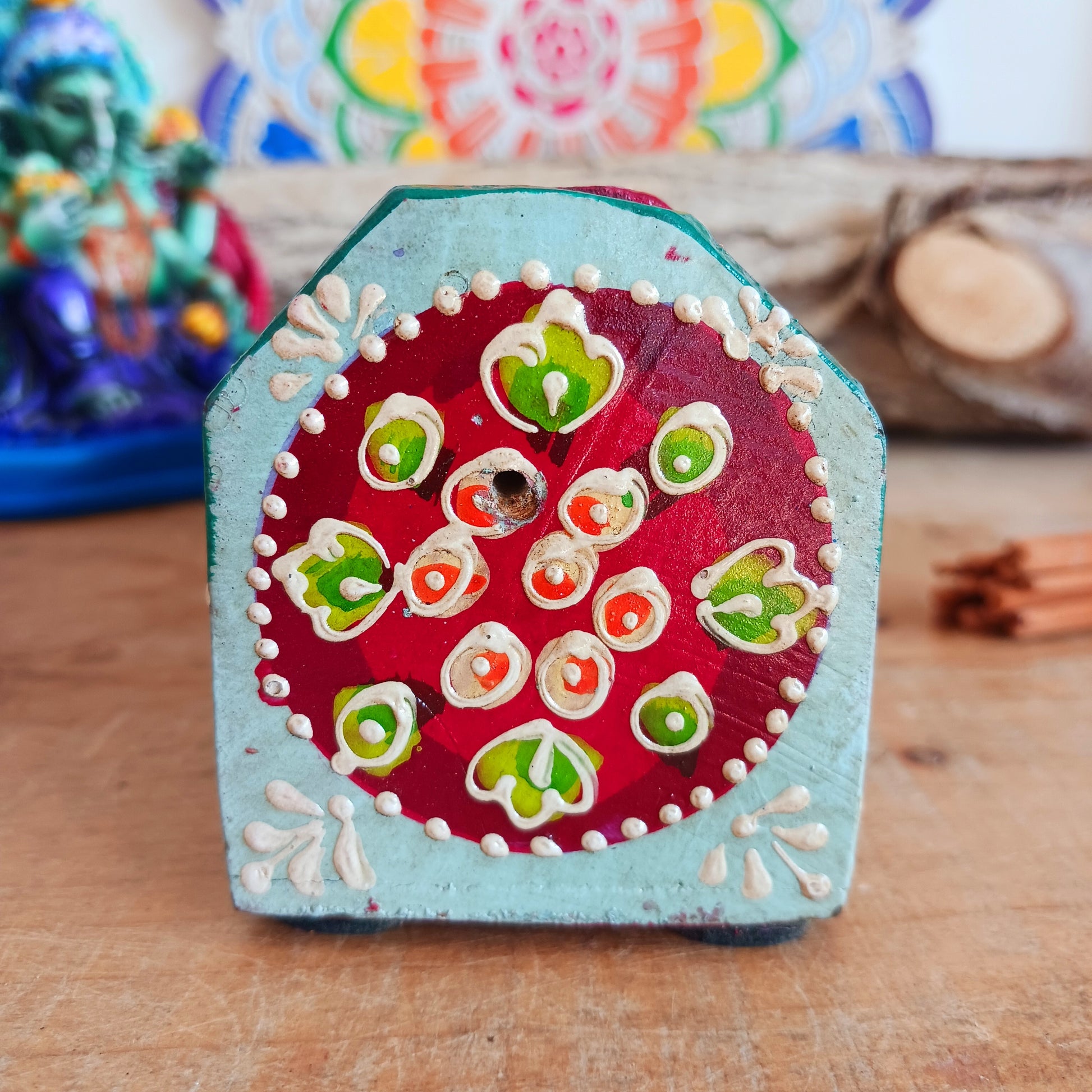 This beautiful turquoise wooden Incense box has been hand painted and has a curved hinged lid. It can accommodate both incense sticks and cones. There is also a place for you to safely store your incense sticks at the bottom on the box.