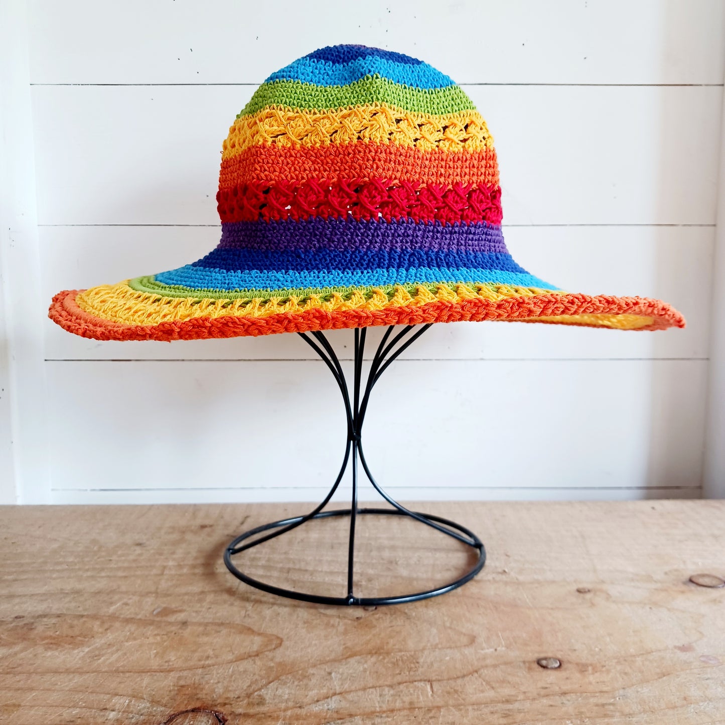 Brighten up your summer with this vibrant handmade crochet cotton sun hat! Featuring a stunning rainbow pattern, this unique hat is perfect for holidays, beach days, and festivals. A malleable wire is carefully woven into the rim, allowing you to shape the brim just how you like it. Lightweight and breathable, it's ideal for sunny adventures. Each hat is individually handcrafted, so you’ll receive the exact one pictured – a one-of-a-kind accessory to celebrate the season in style.