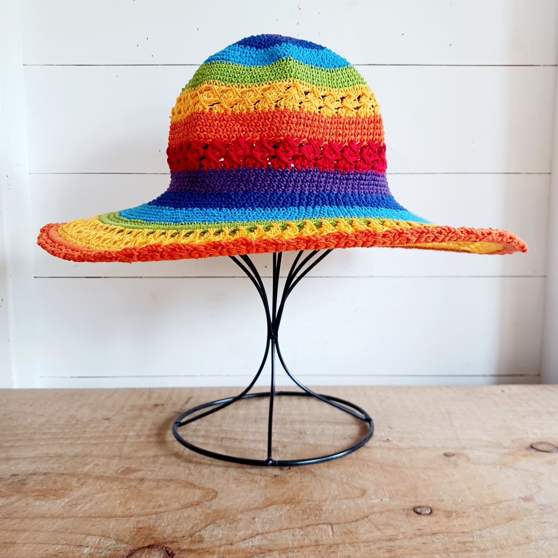 Brighten up your summer with this vibrant handmade crochet cotton sun hat! Featuring a stunning rainbow pattern, this unique hat is perfect for holidays, beach days, and festivals. A malleable wire is carefully woven into the rim, allowing you to shape the brim just how you like it. Lightweight and breathable, it's ideal for sunny adventures. Each hat is individually handcrafted, so you’ll receive the exact one pictured – a one-of-a-kind accessory to celebrate the season in style.