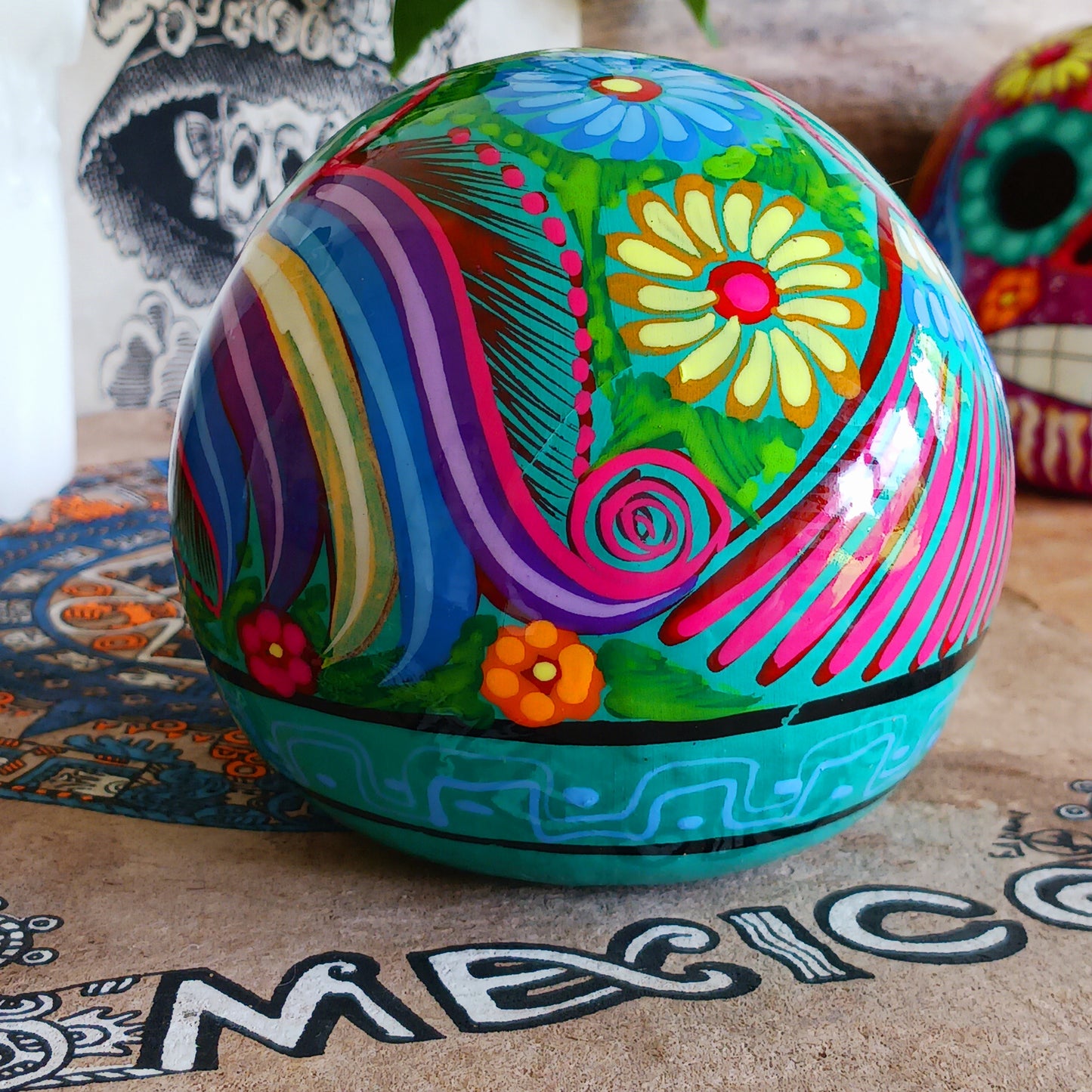 These fun ceramic sugar skull ornaments have been beautifully painted in bright colours and finished with a high shine glaze.  They are a popular item during Día de Los Muertos or Day of the Dead festivities, held in Mexico every November to celebrate welcoming the souls of their deceased relatives back for a time of food, drink and celebration.