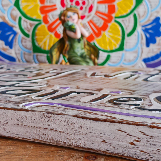 Whimsical handmade wall plaque with fairy-themed design. Ideal for gardens or interiors. Crafted in Indonesia with etched text and colourful star accents.