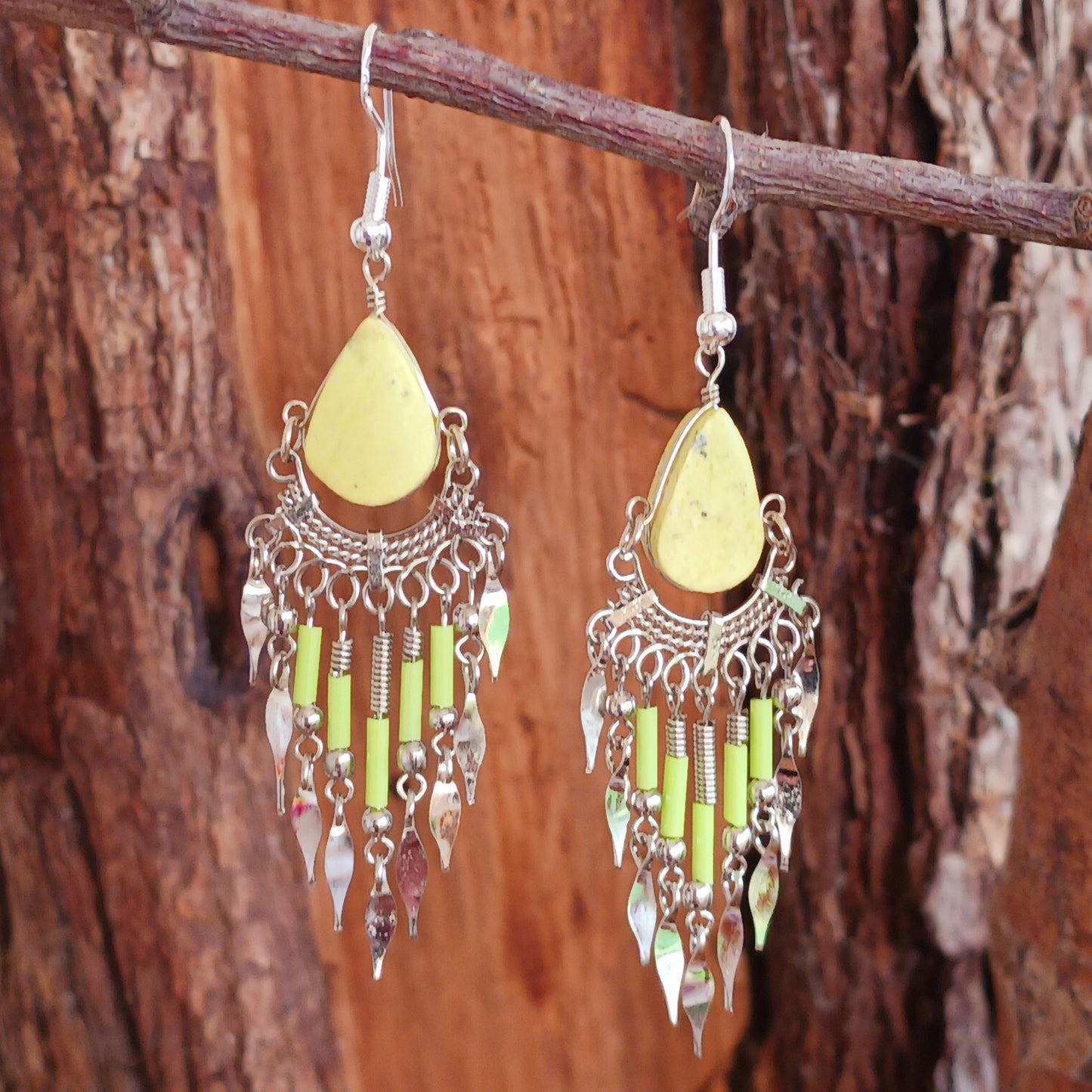 Add a touch of bohemian beauty to your look with these handmade Peruvian yellow stone and beaded earrings. Featuring a pale yellow stone paired with matching beads and finished with silver-plated hooks, each pair is carefully crafted in small workshops in Peru.