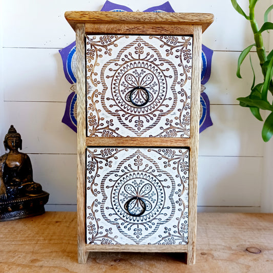 Bring balance and beauty to your space with this handcrafted mango wood drawer cabinet, featuring an intricate mandala design on the front panels. Perfect for organising your wellness accessories, stationery, jewellery, or essential oil droppers, this piece combines practicality with mindful artistry. 