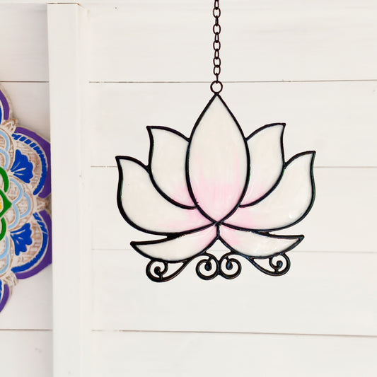 Bring a touch of tranquility to your space with this beautifully crafted lotus flower window hanger. Made from coloured glass and outlined in sleek metal framing, this piece combines simplicity and elegance. When sunlight passes through, it creates a radiant, uplifting display of colour. Hang it in any window to inspire peace, mindfulness, and beauty in your home or workspace.