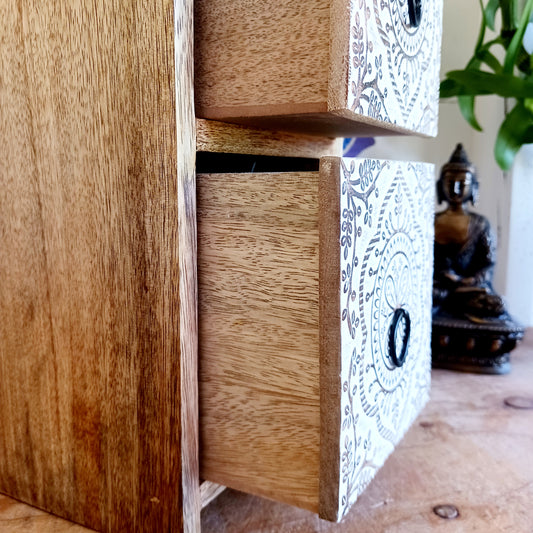 Bring balance and beauty to your space with this handcrafted mango wood drawer cabinet, featuring an intricate mandala design on the front panels. Perfect for organising your wellness accessories, stationery, jewellery, or essential oil droppers, this piece combines practicality with mindful artistry. 