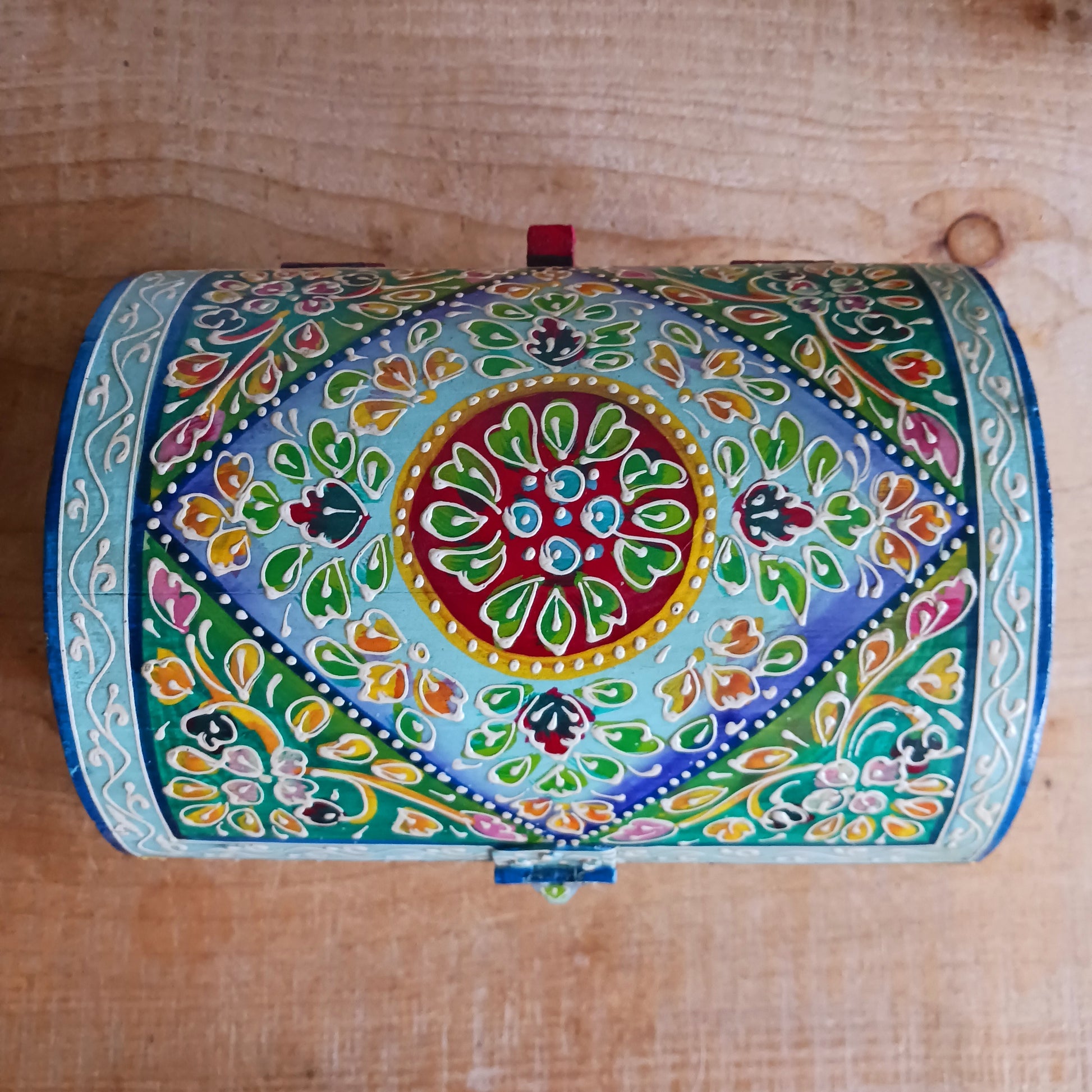 Add a touch of artisan charm to your home with this beautiful handmade and hand-painted domed wooden box, featuring a striking turquoise floral pattern. Carefully crafted in India, each piece showcases traditional craftsmanship and vibrant detailing, making every box truly unique.