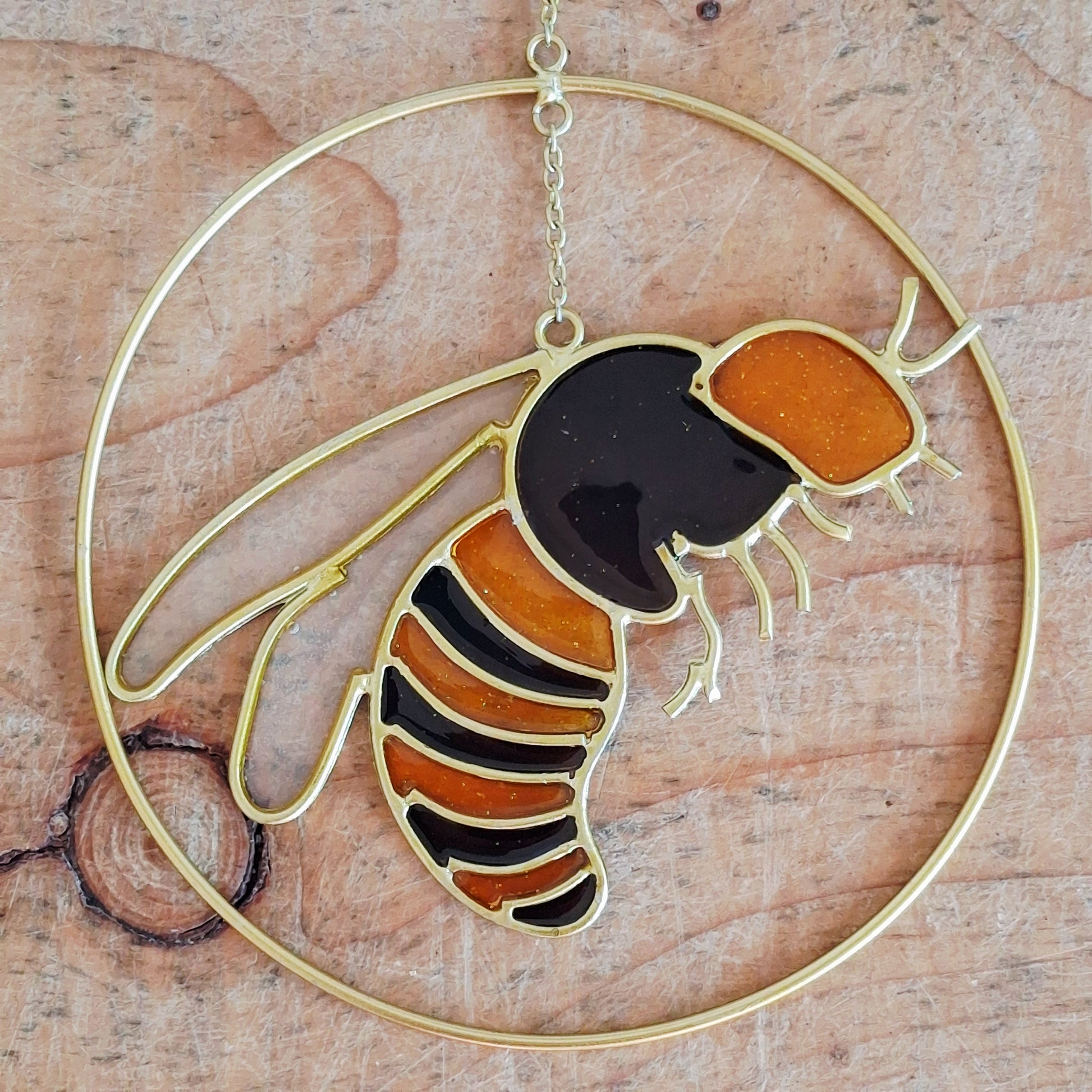 Add a touch of sunshine to the home with this summer bee suncatcher. This charming suncatcher features a beautifully detailed bee, star and crescent moon design made from metal and resin. Hang it in the window to catch the light and bring a cheerful, colourful glow to any room.