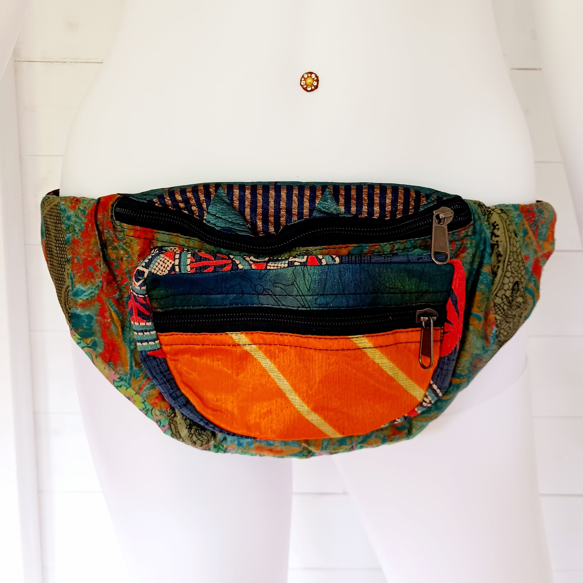 A fun style bum bag made from a patchwork of pretty sari materials. The waistband is adjustable and there is an extra secure zip compartment for easy access. This bag can also be worn across the body for extra security.
