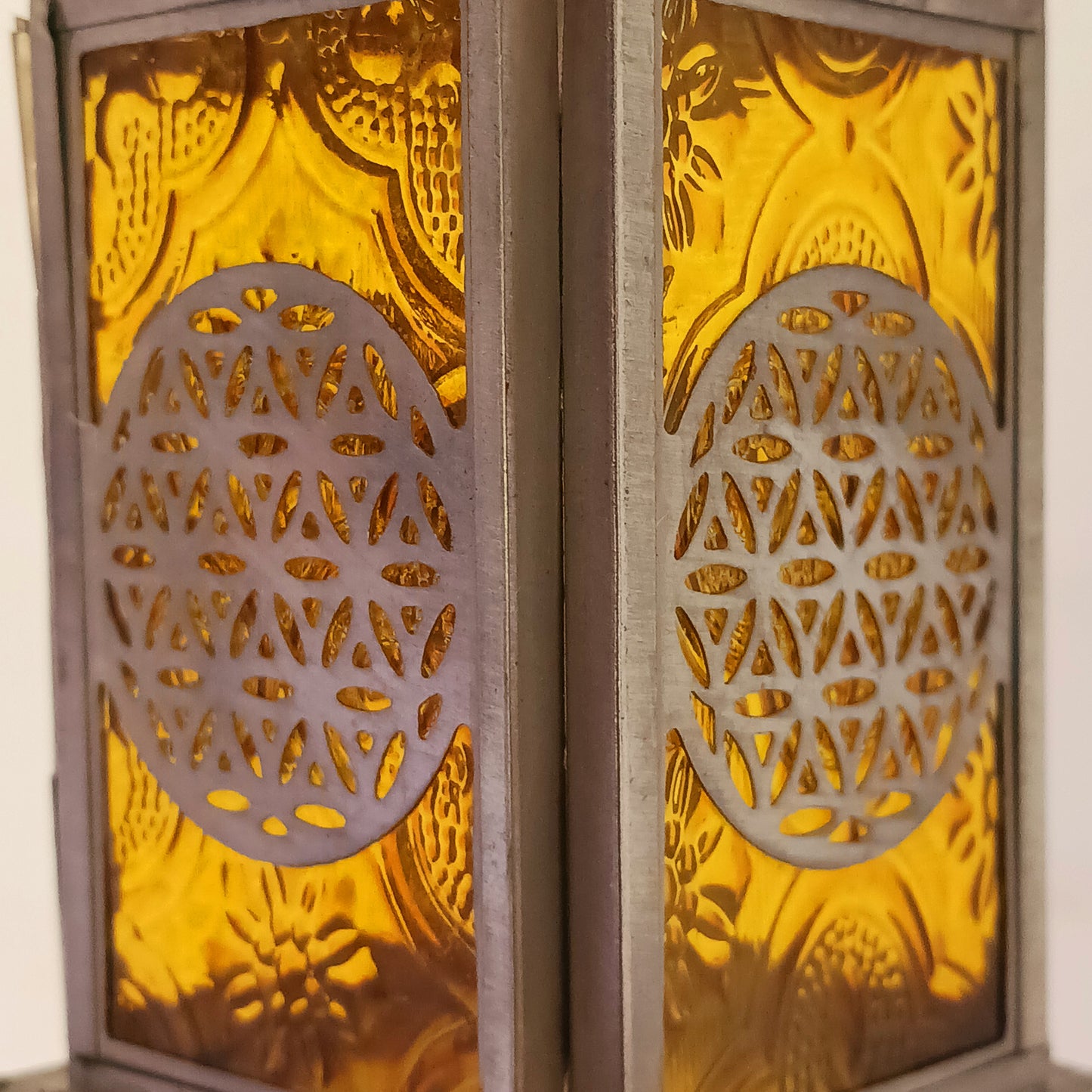 Bring warmth, colour and spiritual harmony to your home with this beautiful Tree of Life Glass Lantern. Designed with vibrant coloured glass panels and a decorative metal cut-out canopy, this lantern creates a calming glow that enhances meditation spaces, yoga rooms and home décor.