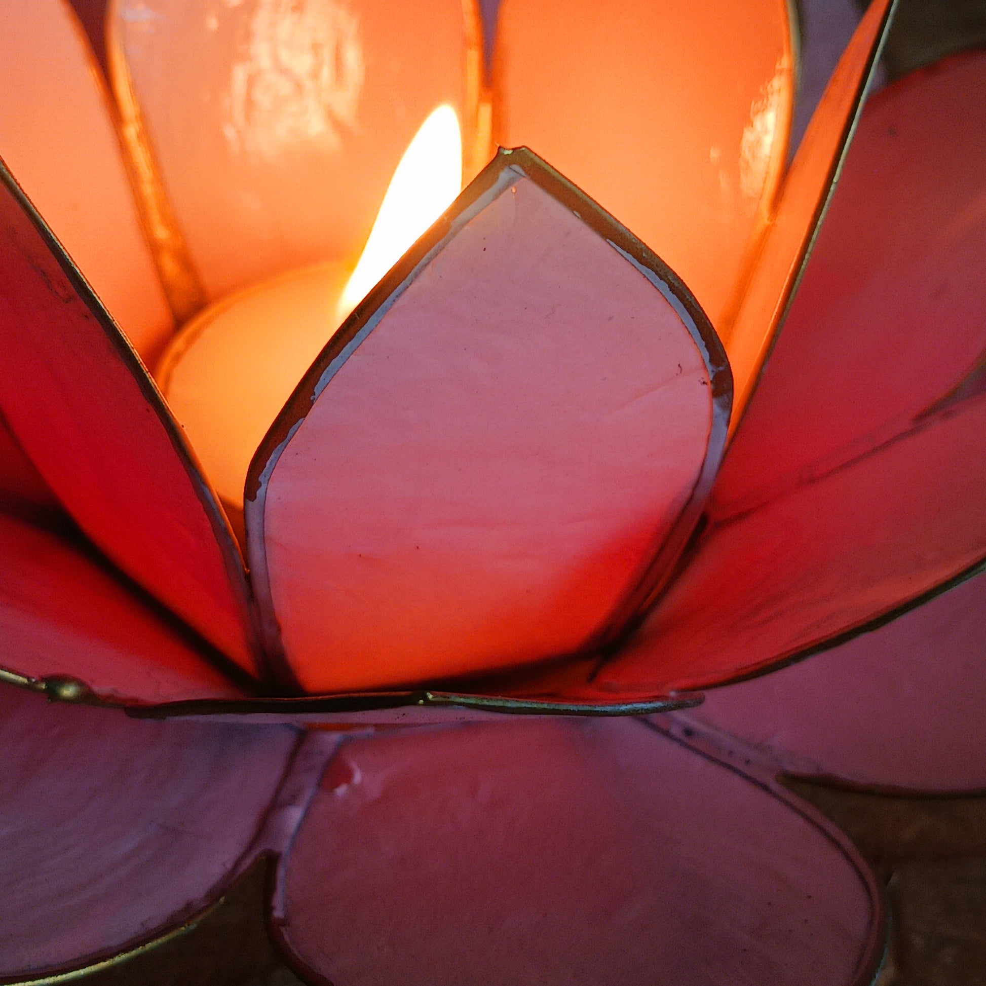 Crafted from natural Capiz shells sustainably harvested from the Philippines, this Fairtrade candle holder accommodates tealight or small candles up to 5.5cm in diameter. The translucent shells bring warmth and beauty to any setting, while celebrating ethical craftsmanship and the artistry of Filipino shell work.
