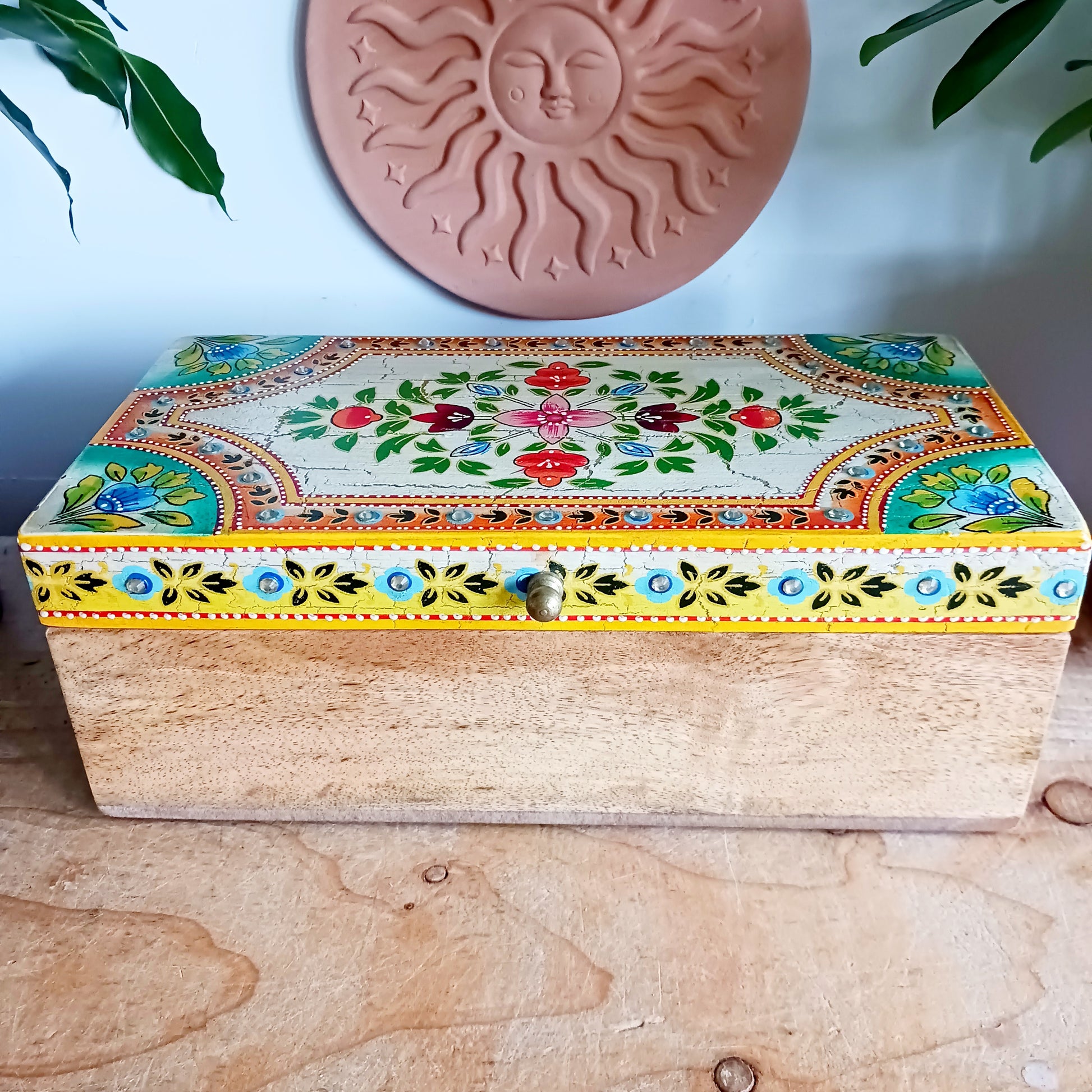 Elevate your home décor with the Zaha Large Decorative Box, a beautifully handcrafted storage piece made from sustainable mango wood. Expertly handmade and artistically hand-painted, this stunning box features intricate floral detailing on the lid and is finished with an elegant gold-coloured knob for a refined touch.